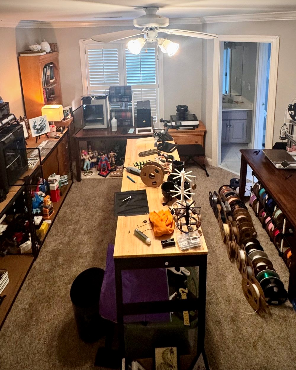 Will Bennett's 3D-printing workshop — print bench, filament shelves, and printers